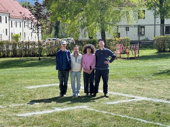 4 Künstler:innen stehen im Park