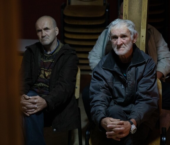 2 Männer sitzen im warmen Nachtasyl