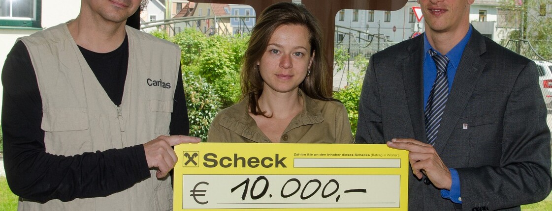 Spendenübergabe der Firma Traunfellner. Geschäftsführung übergibt Spendenscheck an Caritasmitarbeiter Andreas Zinggl.