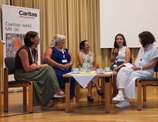Fünf Frauen im Gespräch sitzend.