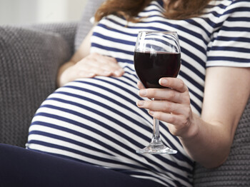 Close Up Of Pregnant Woman Drinking Red Wine