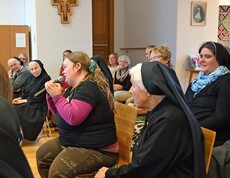 Viele Menschen, auch Nonnen in einem Saal